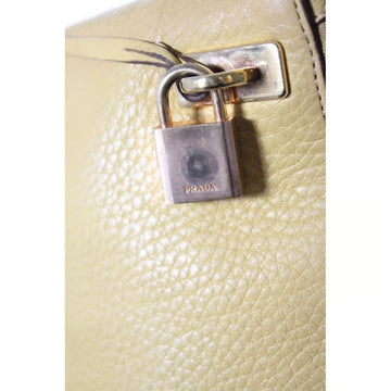 Vintage 90s Prada, yellow grained leather, hobo-style satchel with top zip, gold hardware, & padlock/keys