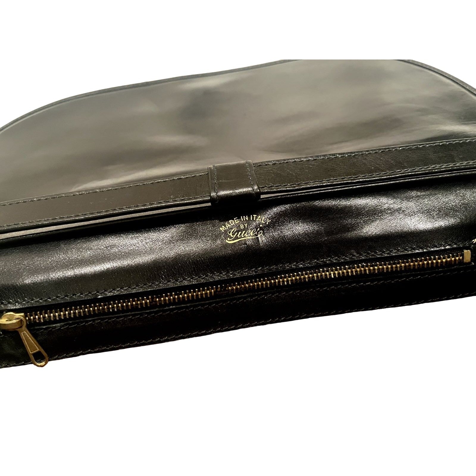 Vintage, rare, black leather, Gucci shoulder bag with a large, two-tone 'GG' emblem and removable strap