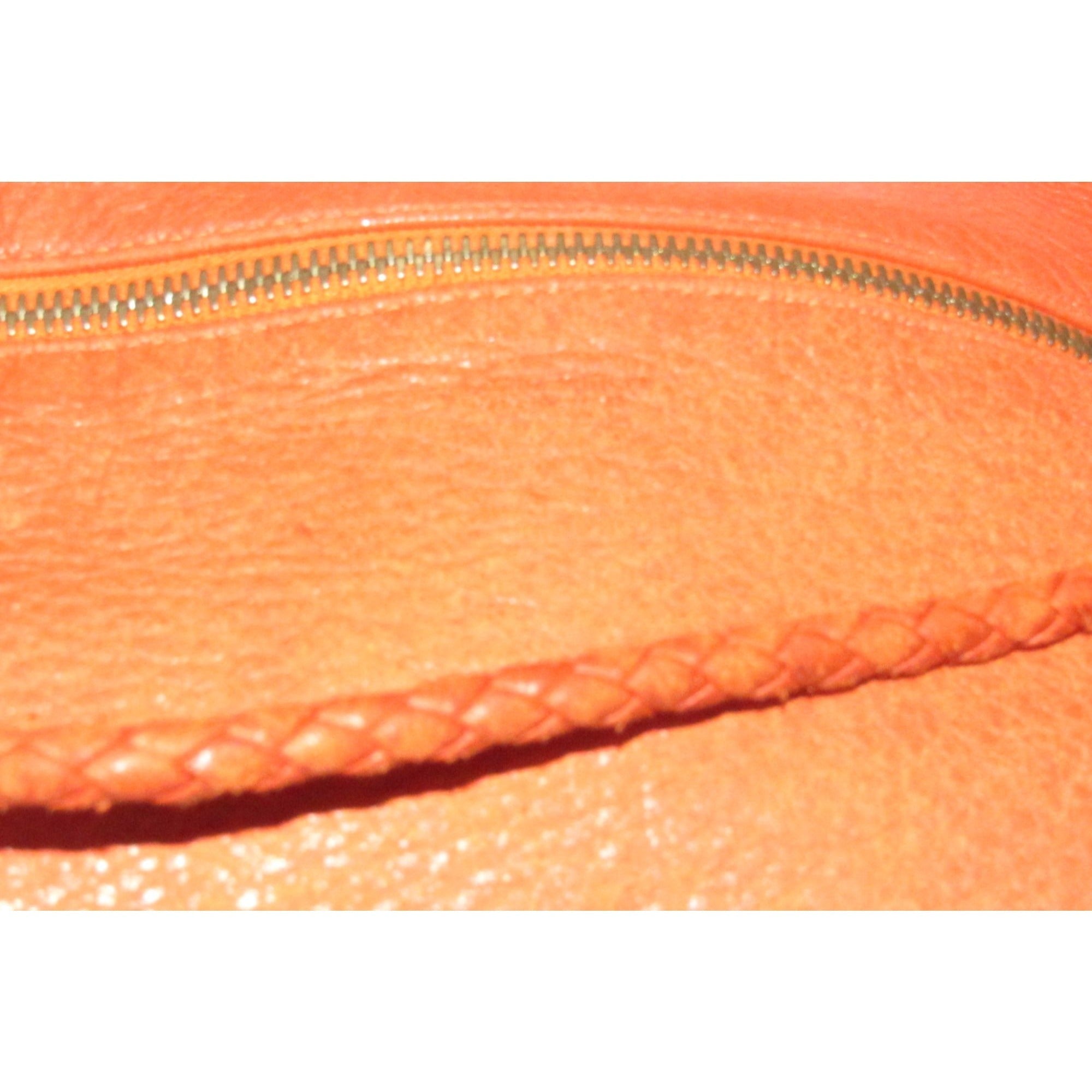 High- end bohemian, RARE, Bottega Veneta, orange leather with a braided leather strap and trim, satchel style, bucket purse