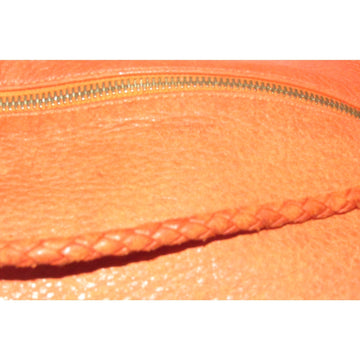 High- end bohemian, RARE, Bottega Veneta, orange leather with a braided leather strap and trim, satchel style, bucket purse