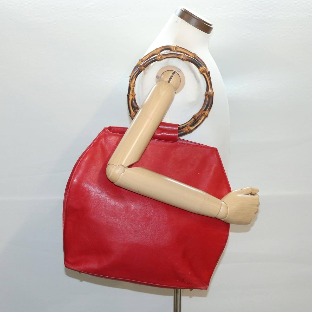 Vintage, mod look, Gucci, true red leather shopper with two round bamboo handles, a footed bottom, and gold accents