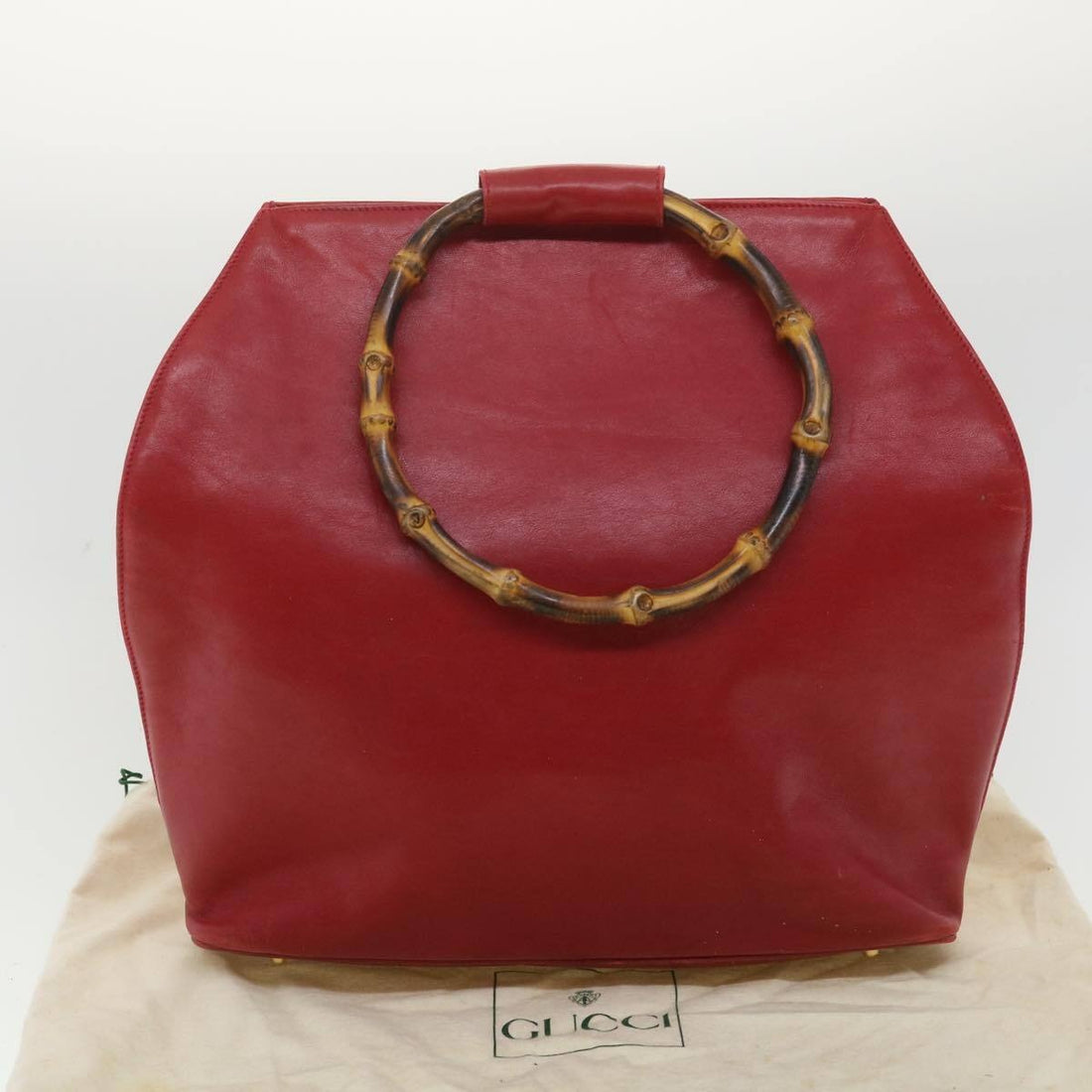 Vintage, mod look, Gucci, true red leather shopper with two round bamboo handles, a footed bottom, and gold accents
