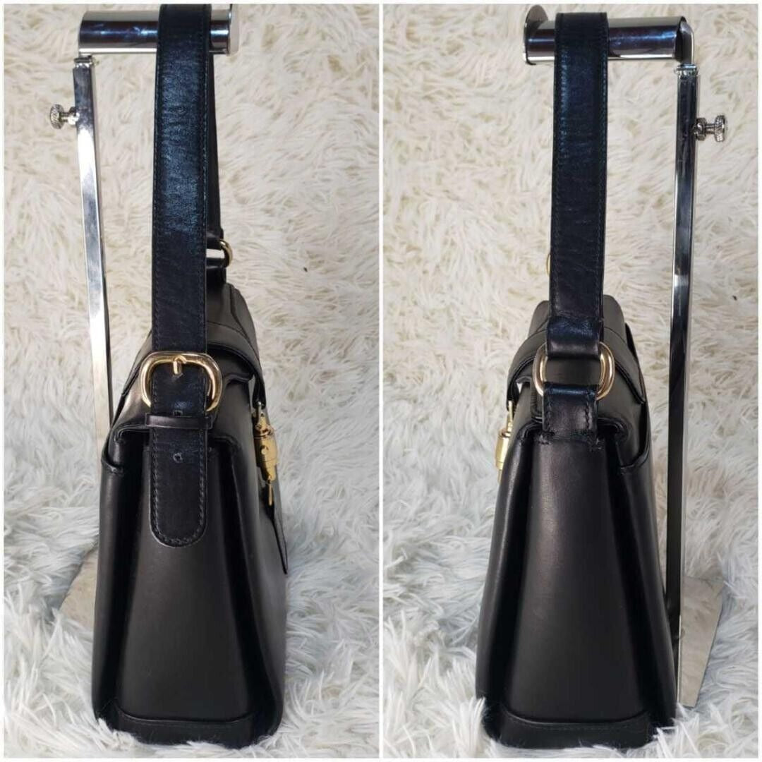 RARE, Gucci, Jackie mod, navy blue leather, boxy, cross body or shoulder purse with bold gold tone accents, a flap strap closure at the cent