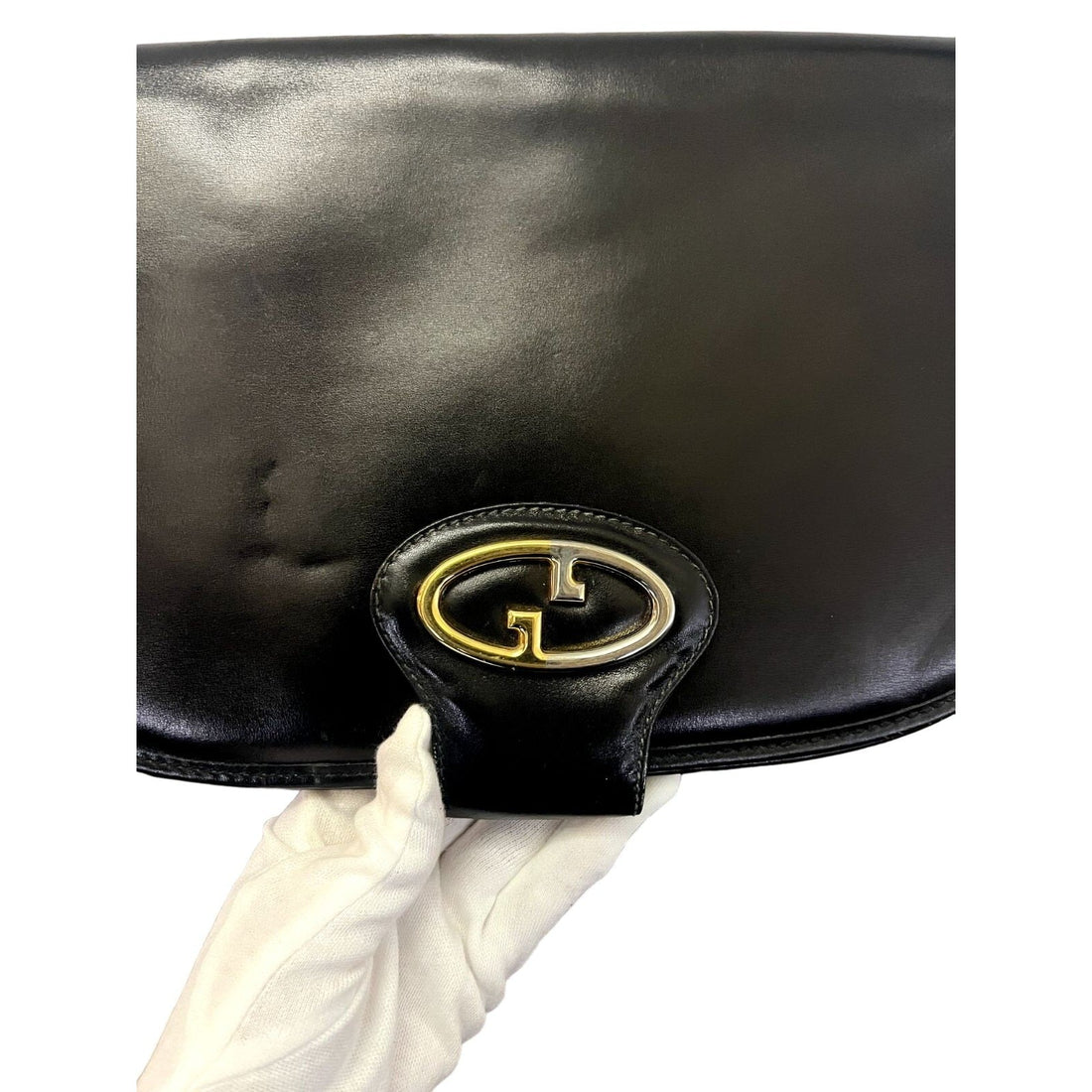 Vintage, rare, black leather, Gucci shoulder bag with a large, two-tone 'GG' emblem and removable strap