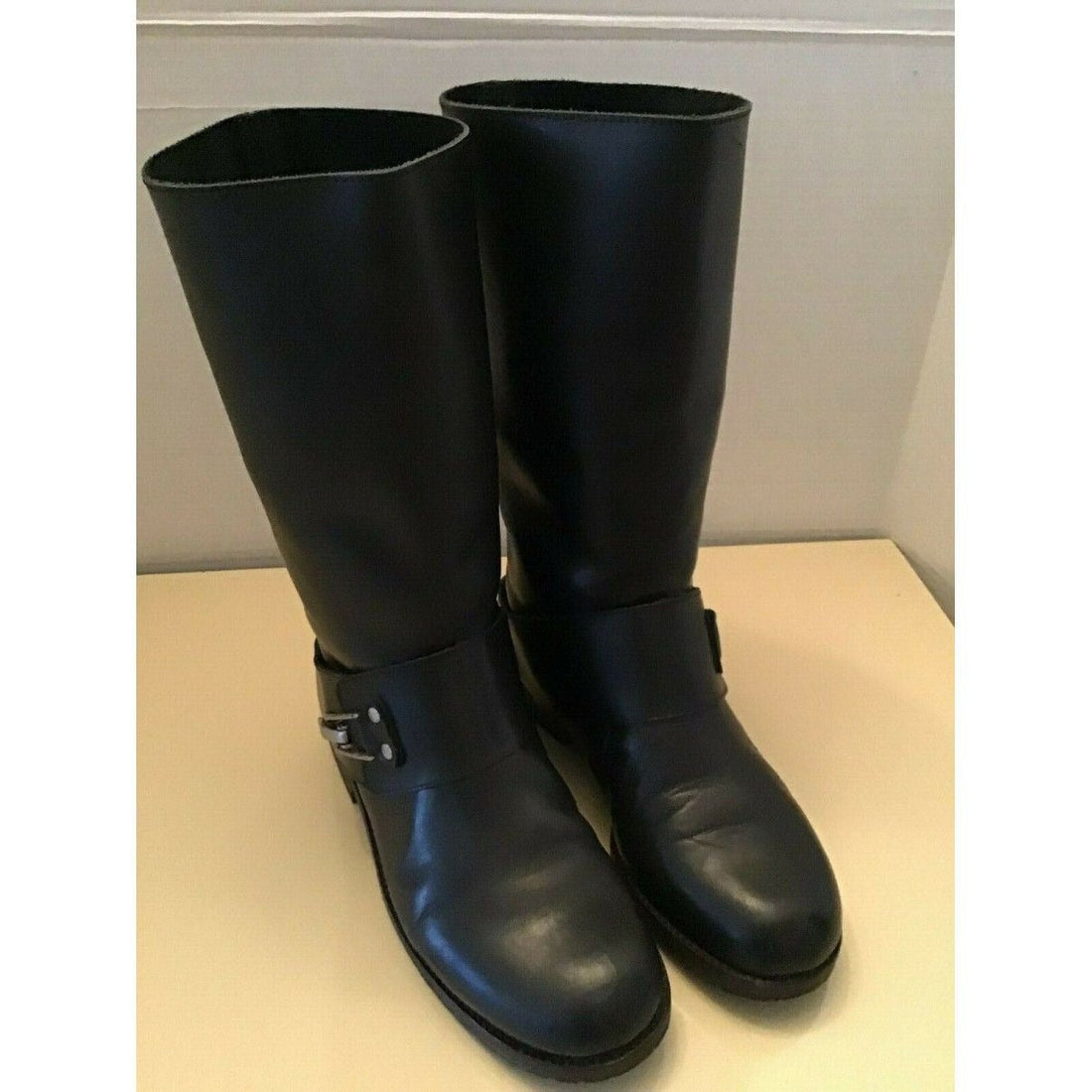 A pair of See by Chloe, size 7, black leather moto style boots with pull on closure, rounded toes, 1" block heels, and chrome buckles
