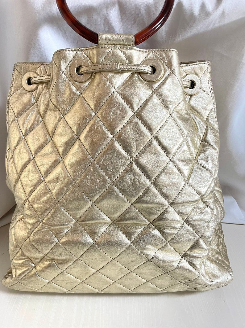 Chanel Vintage campaign gold lamb leather hobo bucket Bag with marble hoop handles and turn lock CC