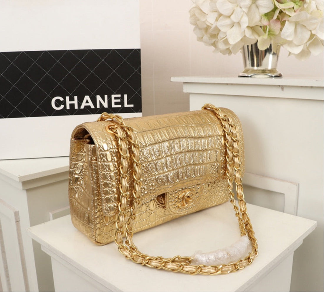 Gold Chanel woman shoulder handbag